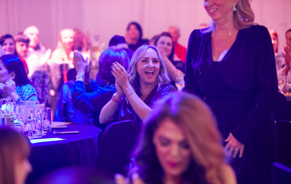 Shot of someone congratulating someone at the No 7 Virtual Training Event awards