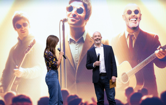 Shot of Davina McCall and John Boumphrey with an AI-altered image of Oasis.