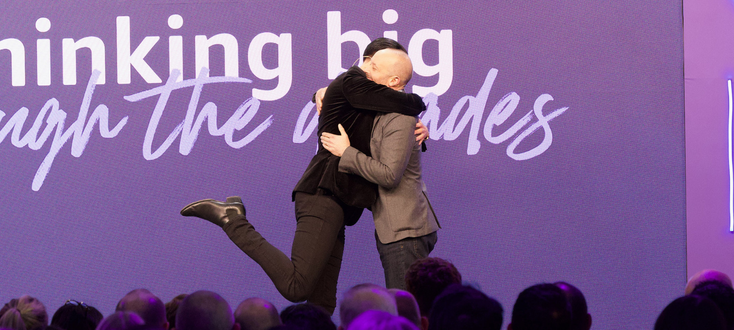 Photo of two people hugging at the Amazon UK & Ireland Event