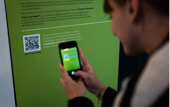 Shot of someone scanning a QR code as part of the Amazon Open Your World campaign