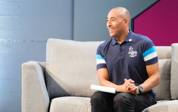 Shot of Colin Jackson presenting the Birmingham 2022 Commonwealth Games Volunteer Orientation Broadcast.