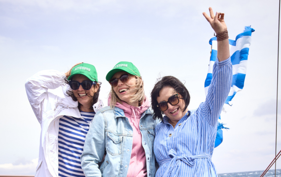 Group shot of three people enjoying a sailing trip during the Vorwerk Mykonos incentive trip.
