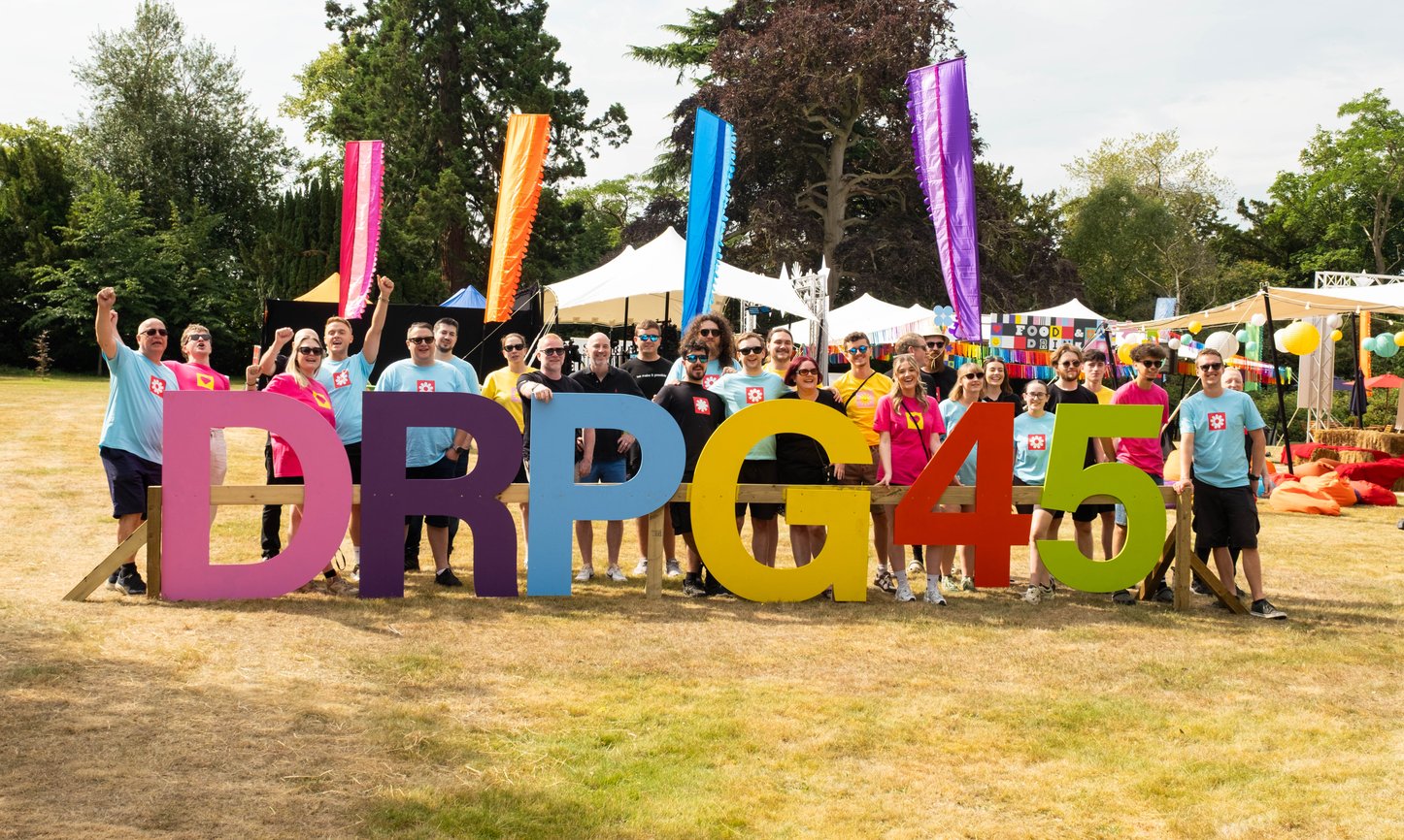 Group shot of team members behind the DRPG 45 sign.