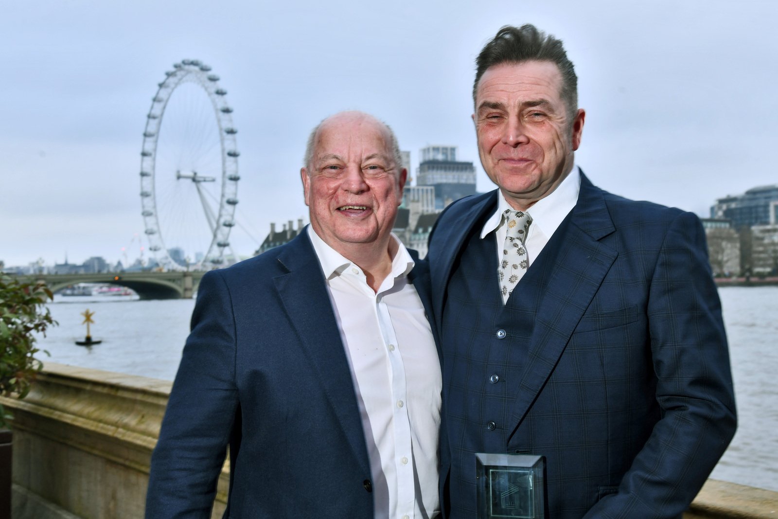 Andrew Smith stands alongside CEO of DRPG, Dale Parmenter in front of the River Thames and the London Eye at EVCOM Fellowship Awards