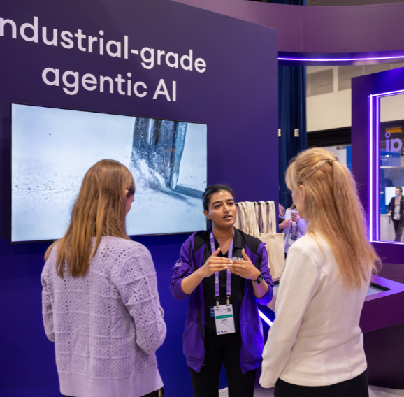 Shot of two customers and a colleague at the international IFS exhibition stands that DRPG created.