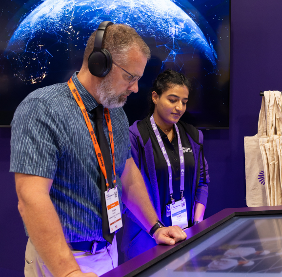 Shot of a customer and a colleague at the international IFS exhibition stands that DRPG created.