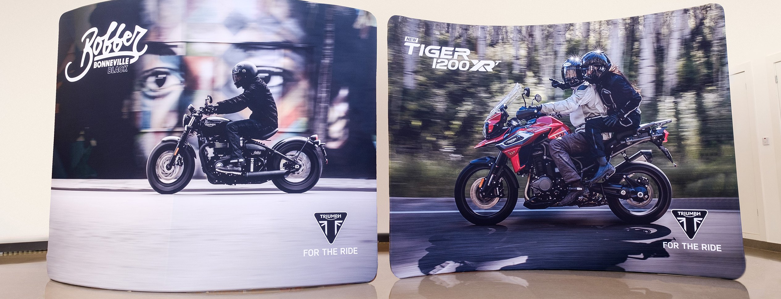 Two large format display banners promoting a pair of Triumph motorcycles
