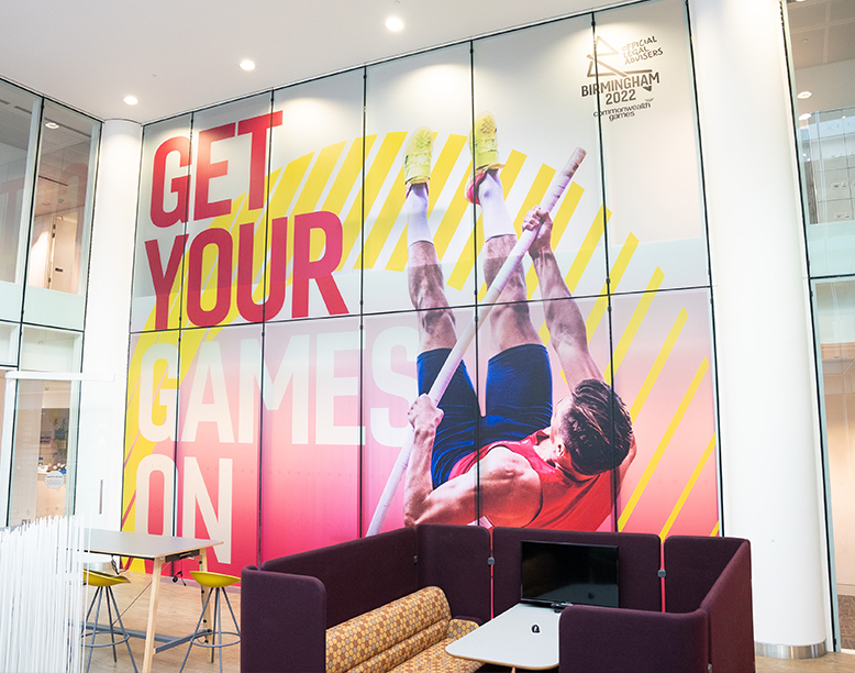 An example of a campaign installation in an office reception for the Birmingham 2022 Commonwealth Games